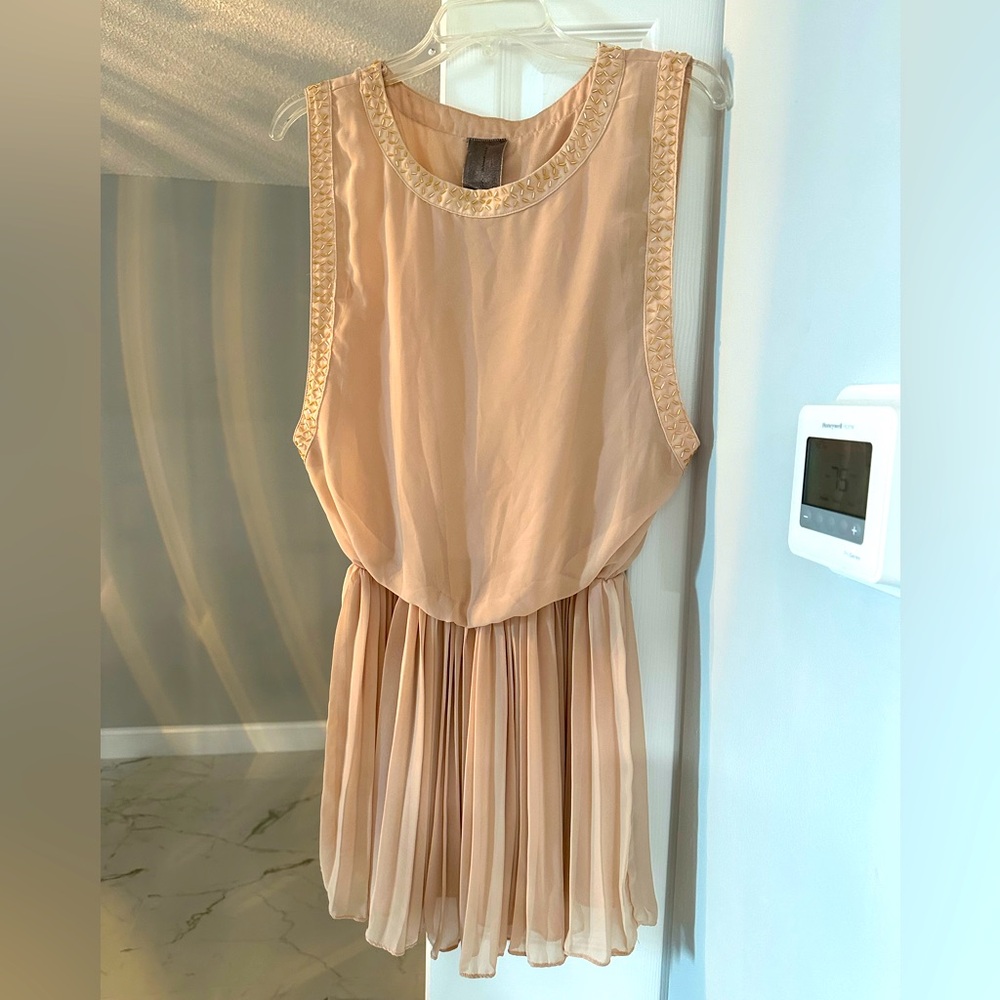Look like an angel in this cream colored dress. Some beading. 
Flary dress.